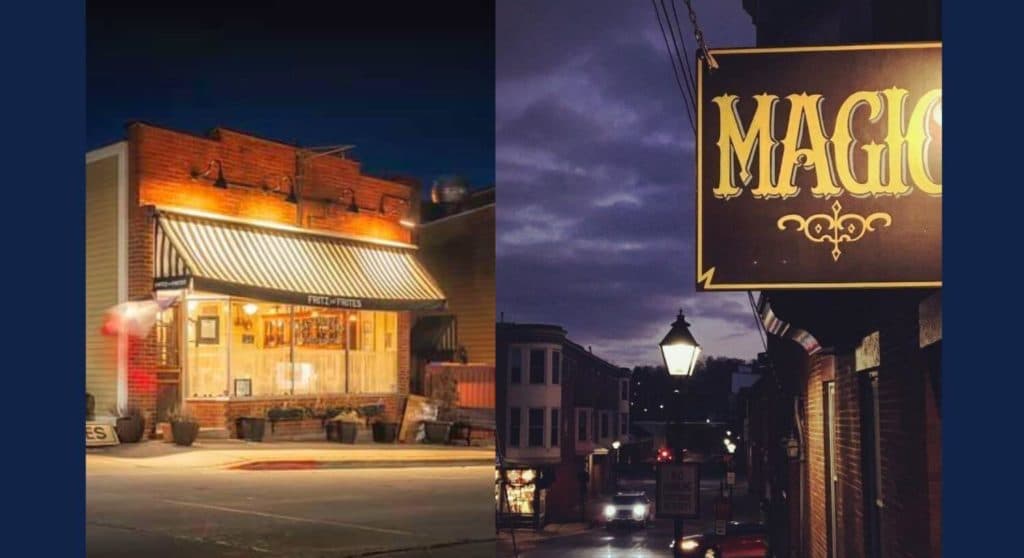 A cozy nighttime view of two shops: one with a striped awning and a sign reading "Fries & Frites," and another illuminated sign that says "Magic."