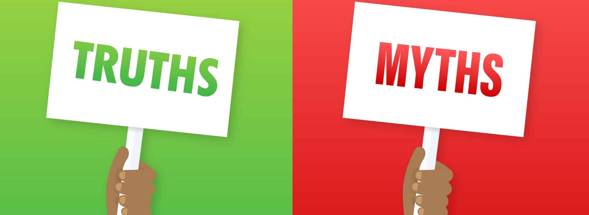 A hand holds a sign reading "TRUTHS" on a green background, while another hand holds a sign reading "MYTHS" on a red background.
